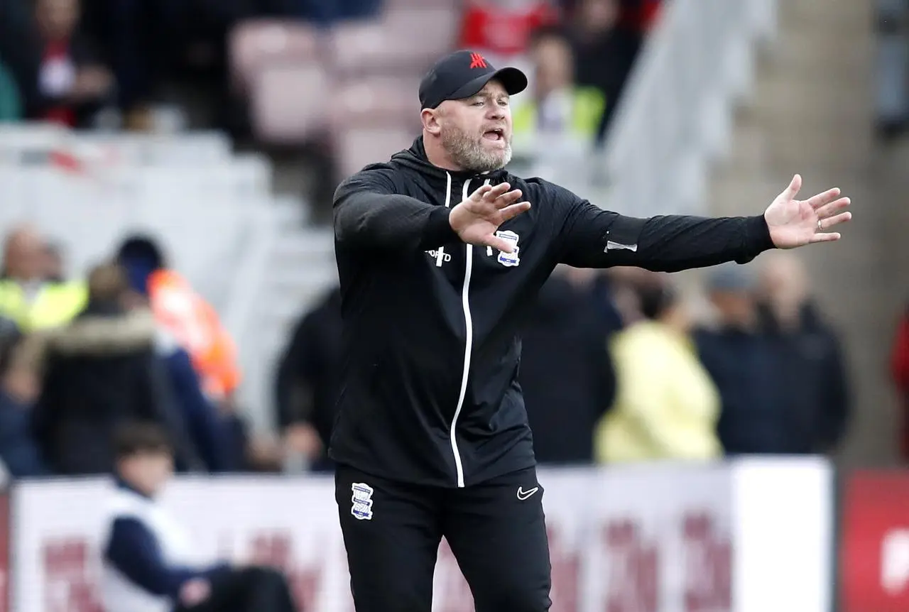 Wayne Rooney gestures to his Birmingham team