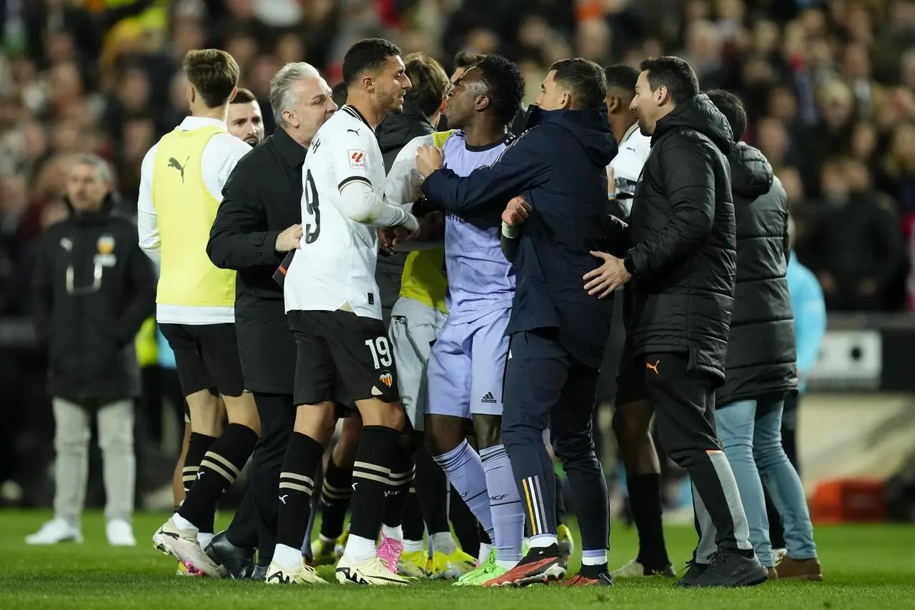 Vinicius Junior is restrained in a chaotic ending to Real Madrid's match at Valencia