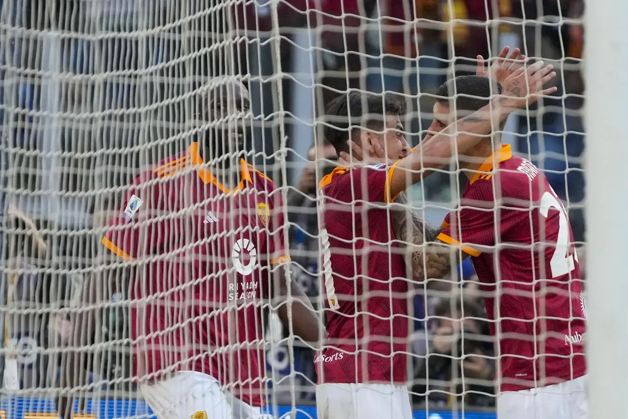 Roma’s Gianluca Mancini (right) celebrates his derby goal against Lazio