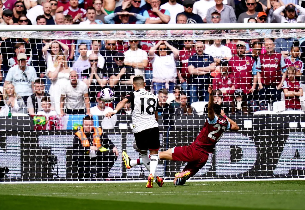 Andreas Pereira, left, scores Fulham’s first goal against West Ham