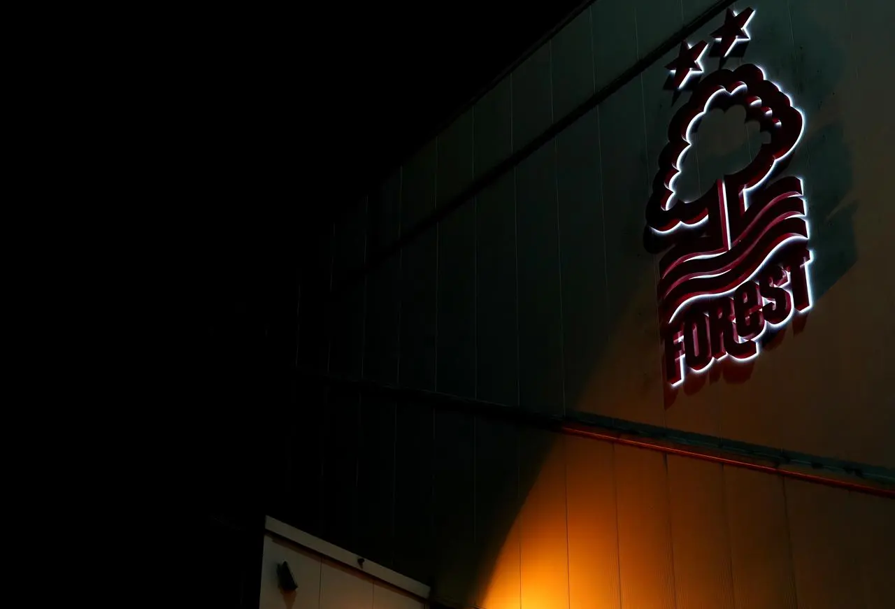 Nottingham Forest's logo lit up at the City Ground for an evening game against Tottenham