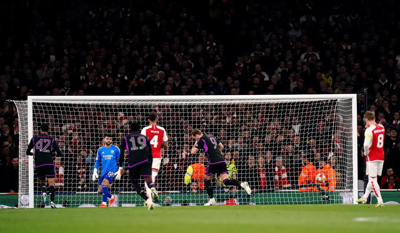 Bayern Munich's Harry Kane, centre right, turns away in celebration after scoring from the penalty spot against Arsenal