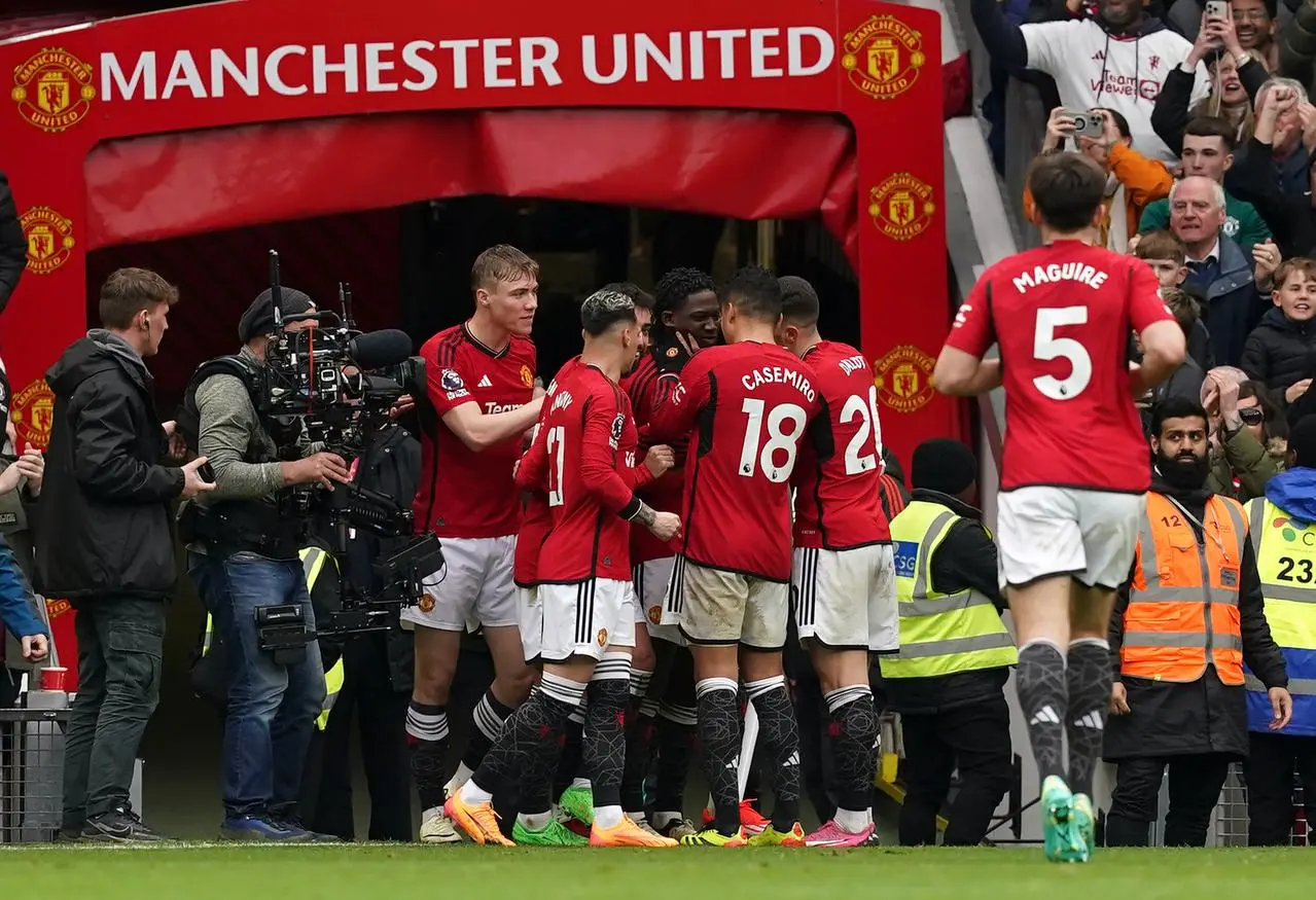 Kobbie Mainoo celebrates with United team-mates after his wonder goal