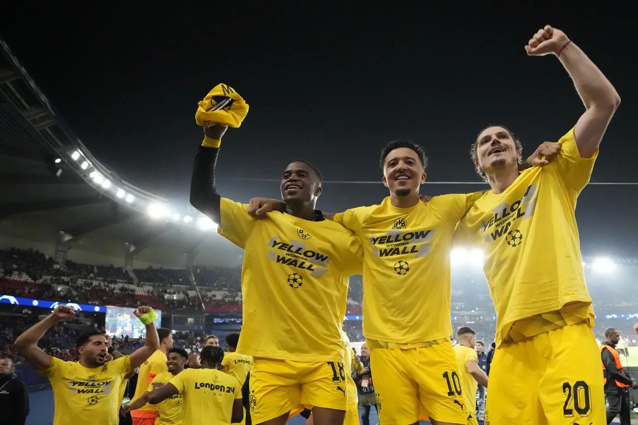 Jadon Sancho, centre celebrates with his Dortmund team-mates at the end of the Champions League semi-final win over PSG