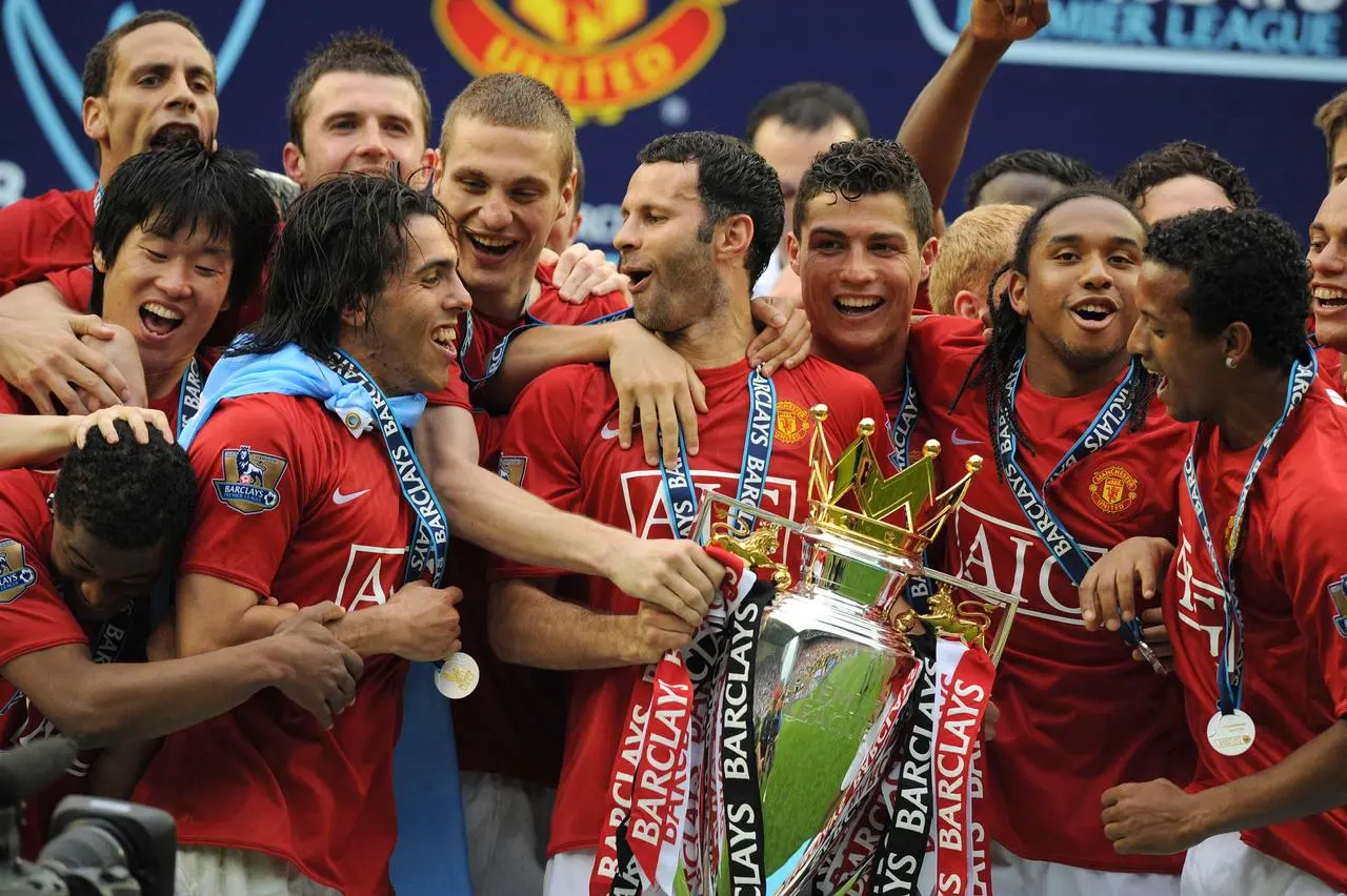 Manchester United celebrates with the Premier League trophy 