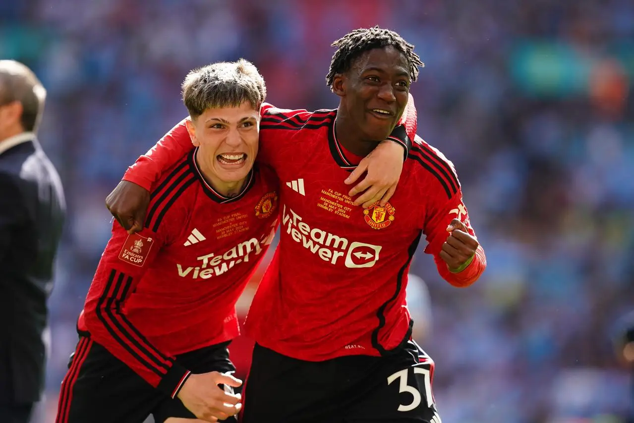 Manchester United goalscorers Alejandro Garnacho, left, and Kobbie Mainoo celebrate after winning the FA Cup