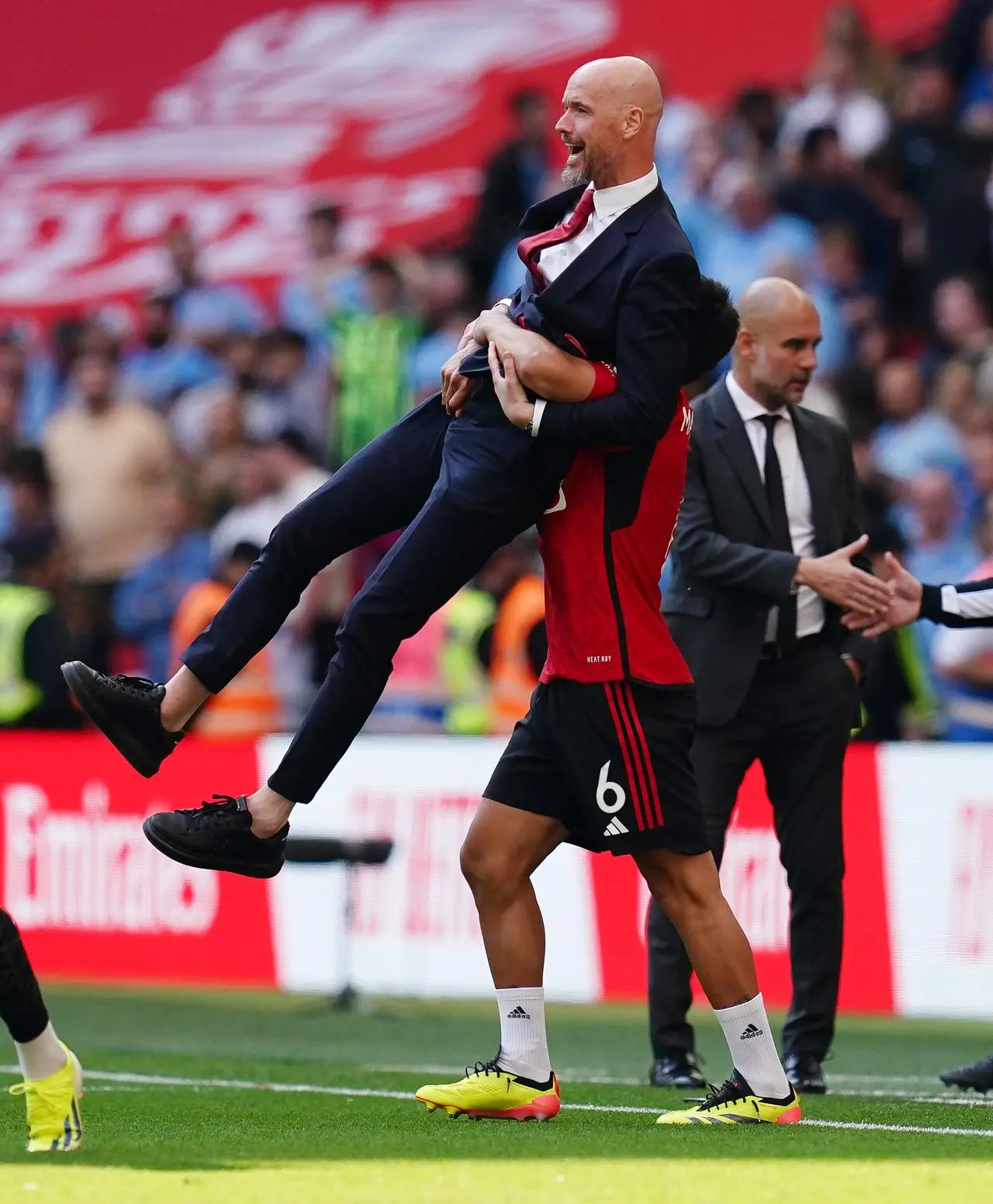 Manager Erik ten Hag, left, is lifted off the ground by Lisandro Martinez as Manchester United celebrate winning the FA Cup