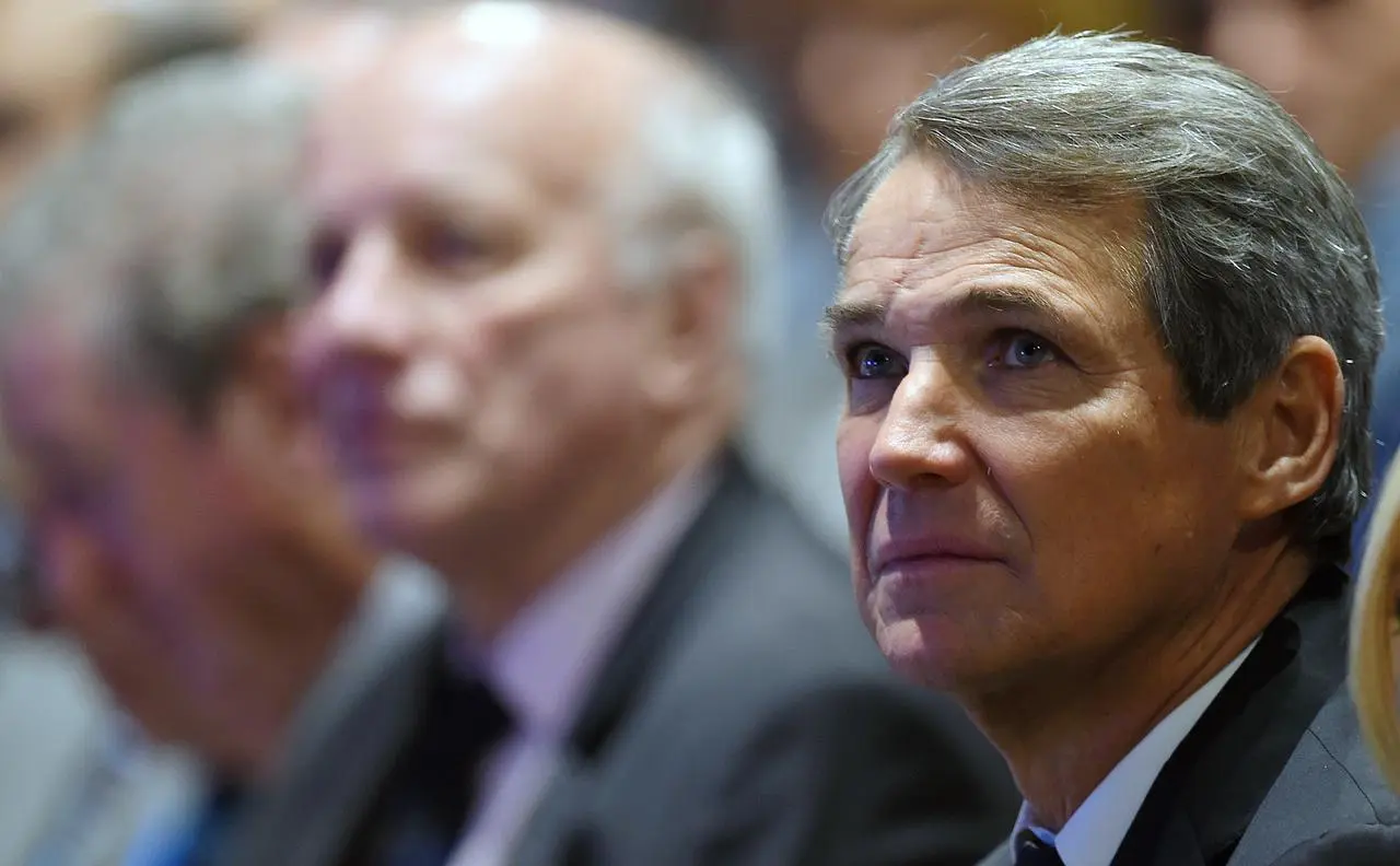 Alan Hansen, right, listens to a service