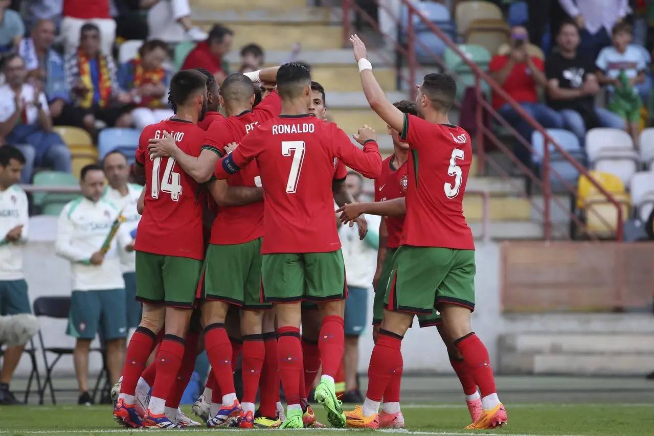 Portugal's players embrace in a group to celebrate Joao Felix's goal against Republic of Ireland
