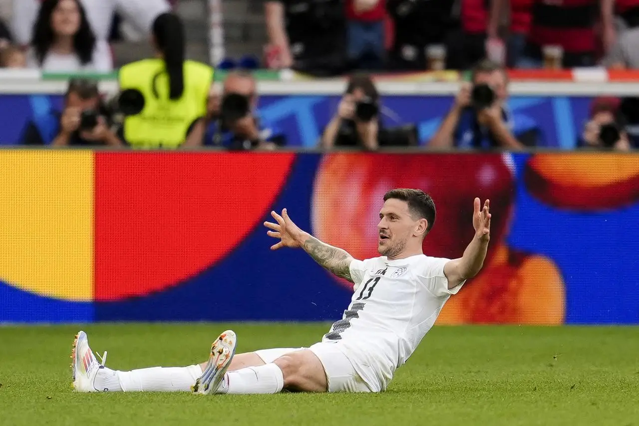 Erik Janza celebrates after scoring Slovenia's equaliser