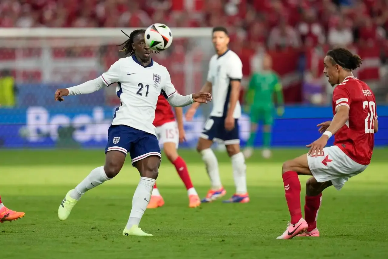 England winger Eberechi Eze tries control the ball past Denmark’s Yussuf Poulsen