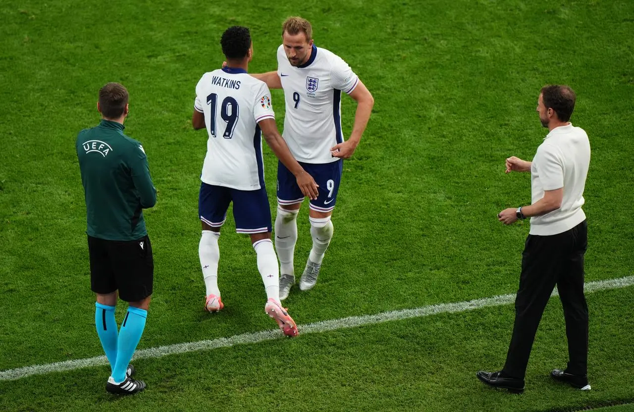 England forward Ollie Watkins embraces Harry Kane as he comes onto the pitch against Denmark