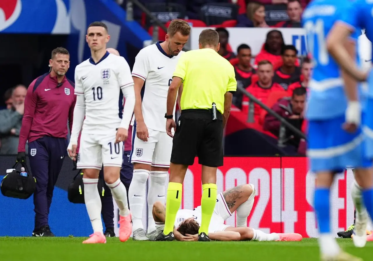 England’s John Stones lies in pain after an early challenge during the Iceland friendly