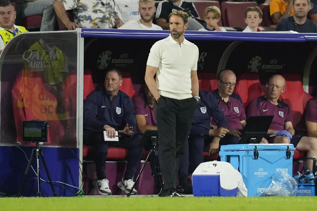 Gareth Southgate stands by the dugout during England's group game against Slovenia