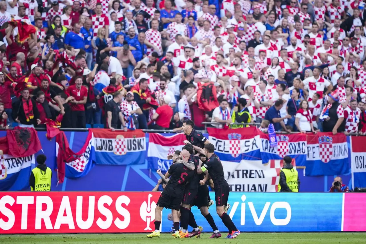 Albania's players celebrate after Klaus Gjasula scores a late equaliser in his side's 2-2 draw with Croatia in Hamburg