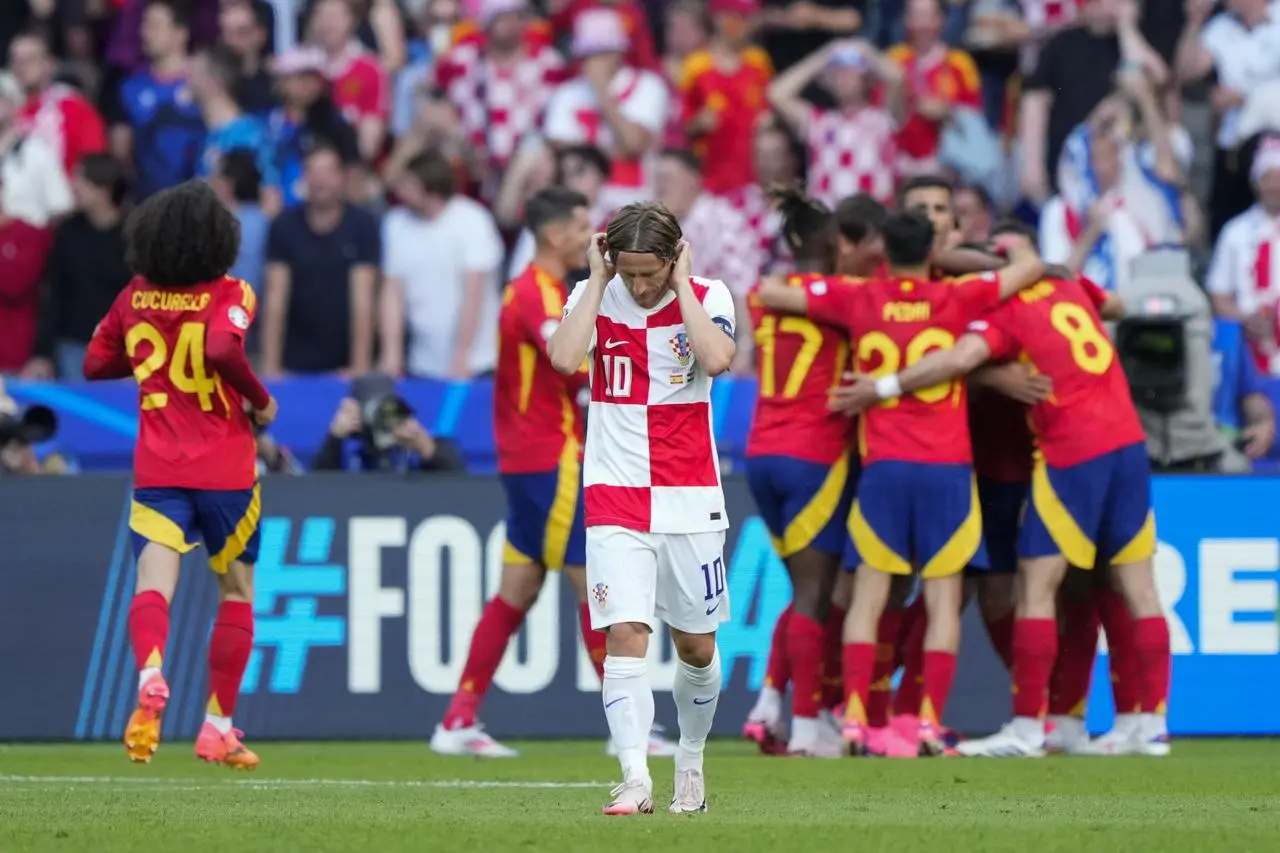 Croatia’s Luka Modric reacts as Spain’s Dani Carvajal is congratulated after scoring in their Group B match at Euro 2024