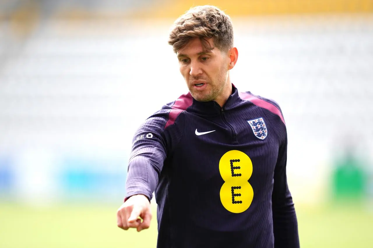John Stones looks forward and points during England training