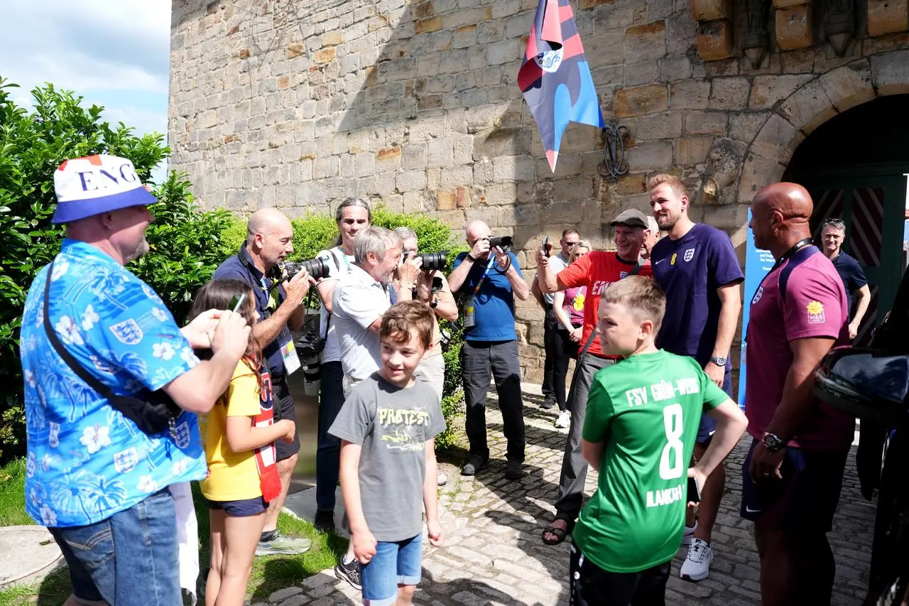 England captain Harry Kane poses for photographs with fans outside their media centre