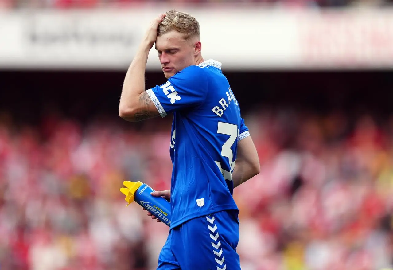 Jarrad Branthwaite brushes hair away from his face with his hand