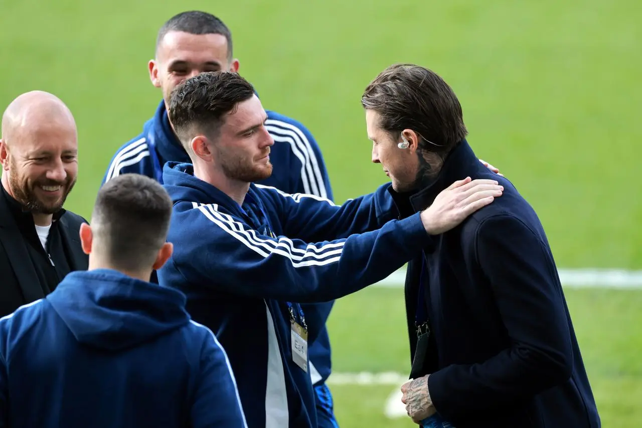 Andy Robertson and Lyndon Dykes embrace