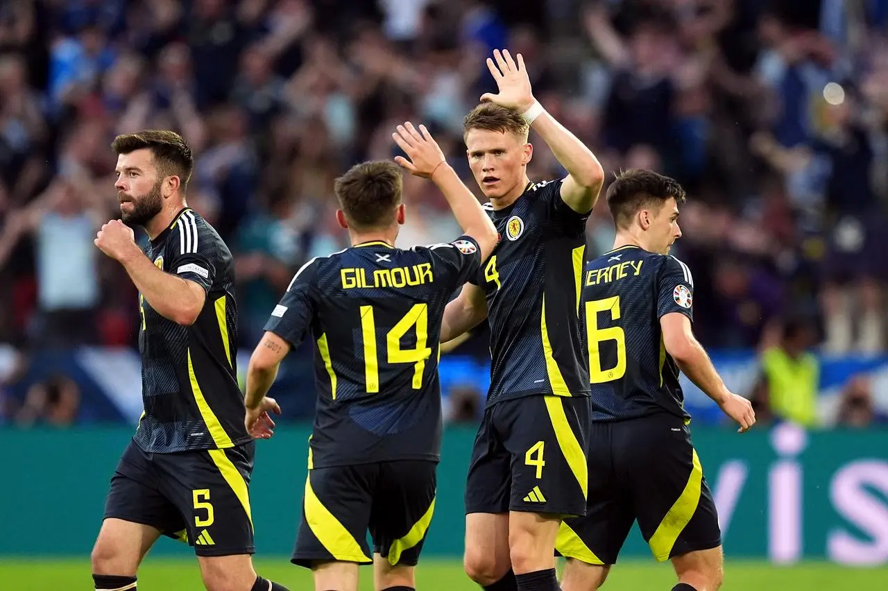 Scott McTominay high-fives team-mates after scoring against Switzerland