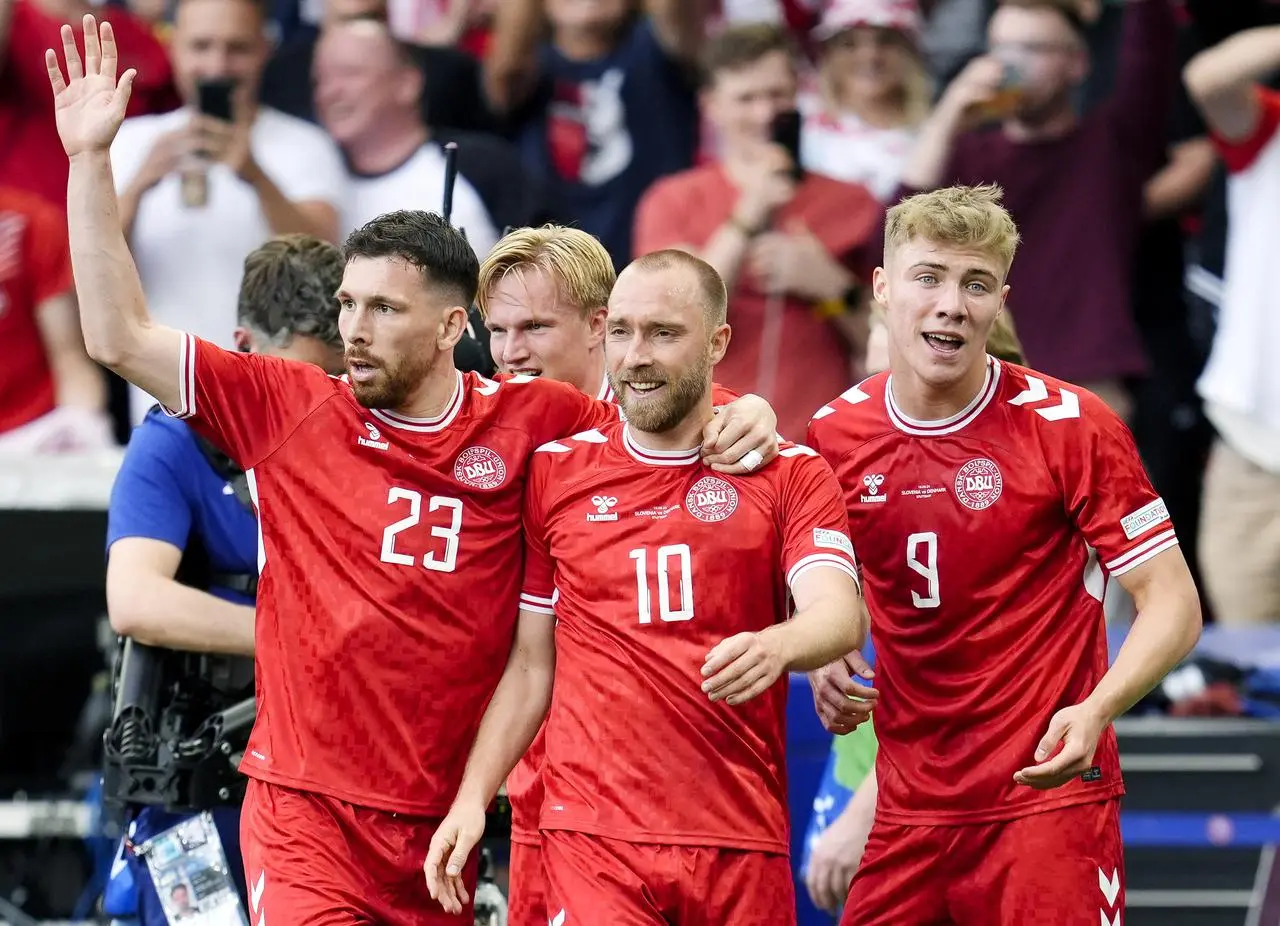 Christian Eriksen (centre) celebrates with team-mates