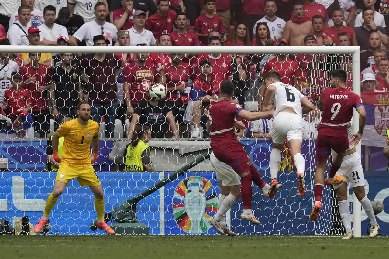 Serbia’s Luka Jovic, centre, heads home in stoppage time