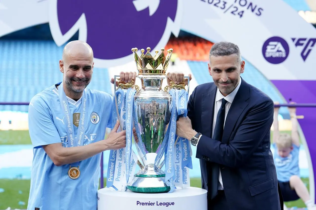 Manchester City manager Pep Guardiola, left, and chairman Khaldoon Al Mubarak with the Premier League trophy