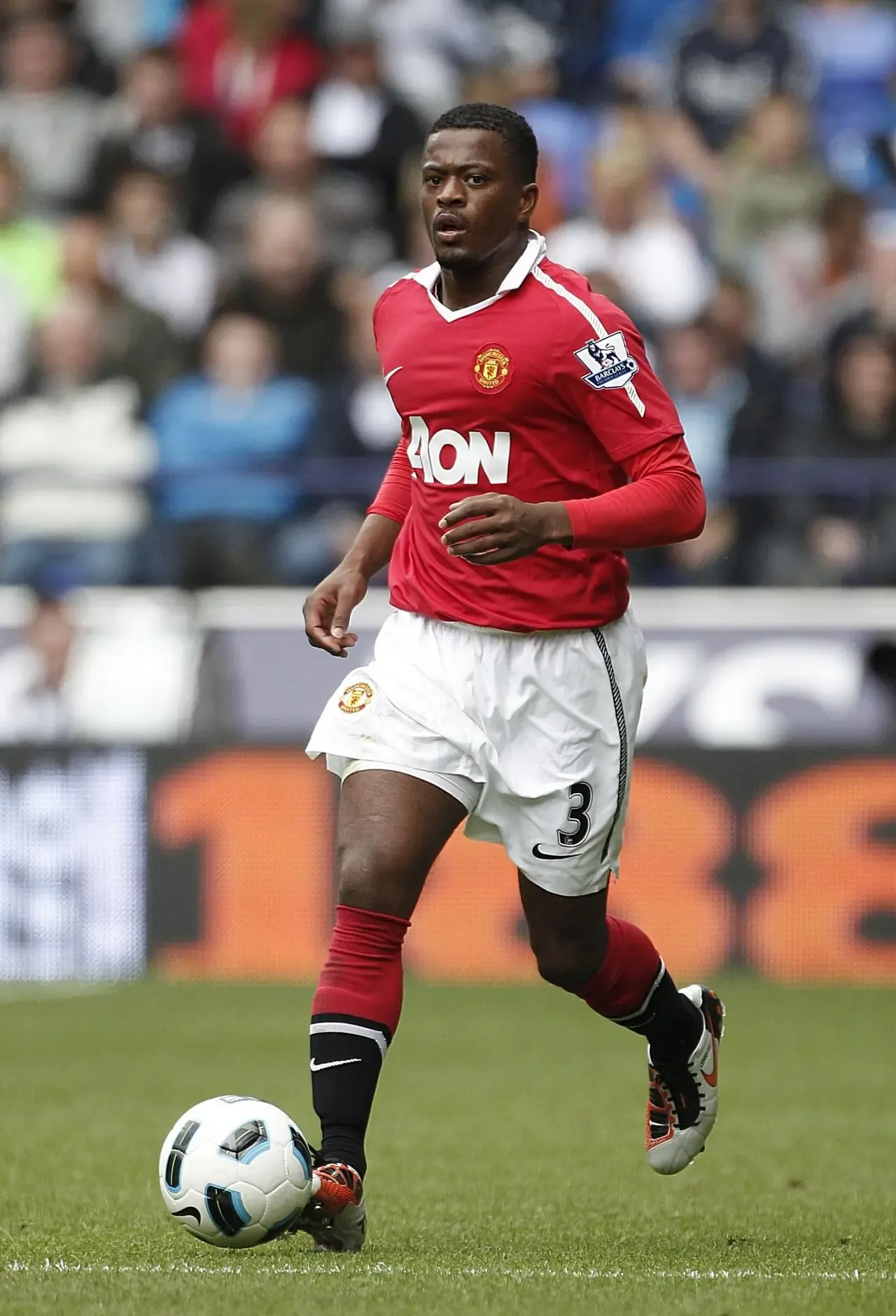 Patrice Evra running with the ball for Manchester United