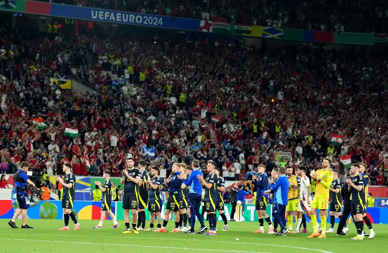 Scotland players stand dejected at full-time of their defeat to Hungary