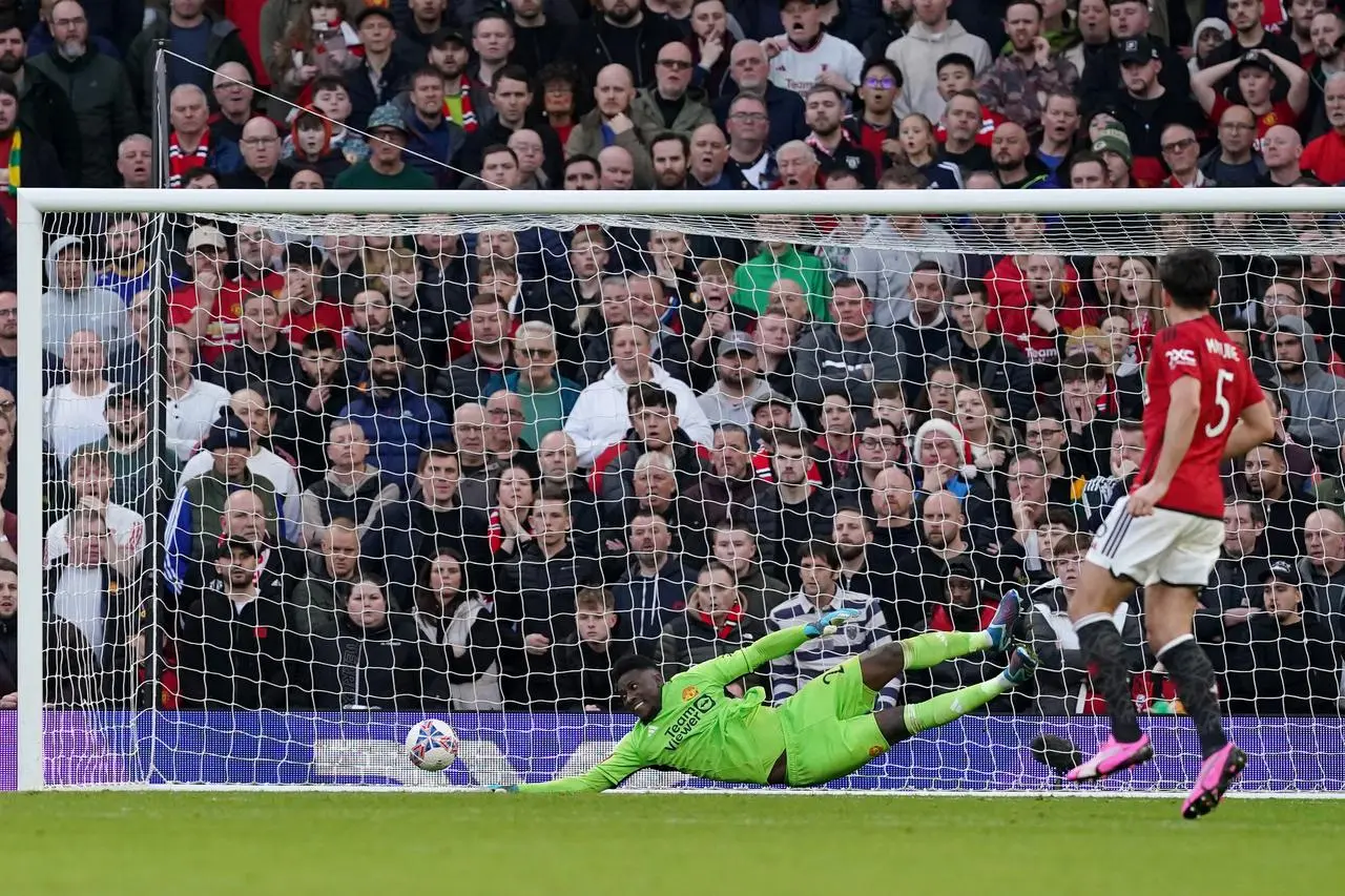 Manchester United goalkeeper Andre Onana, left, is beaten by Liverpool’s Harvey Elliott, not pictured, as Harry Maguire looks on