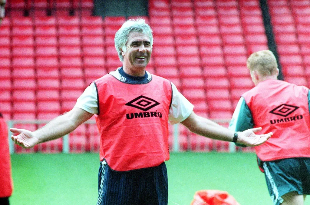 Bobby Gould laughs with his arms out during a Wales training session