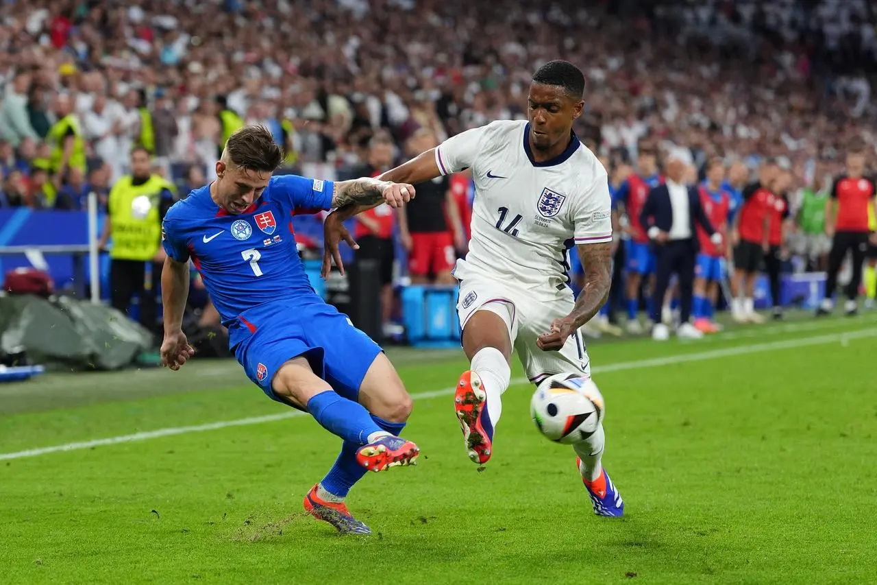 England’s Ezri Konsa, right, challenges Slovakia’s Tomas Suslov