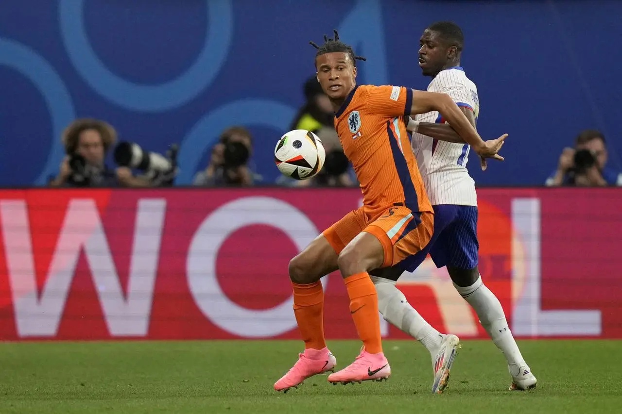 Nathan Ake of the Netherlands, left, is challenged for the ball by Ousmane Dembele of France during a Group D match