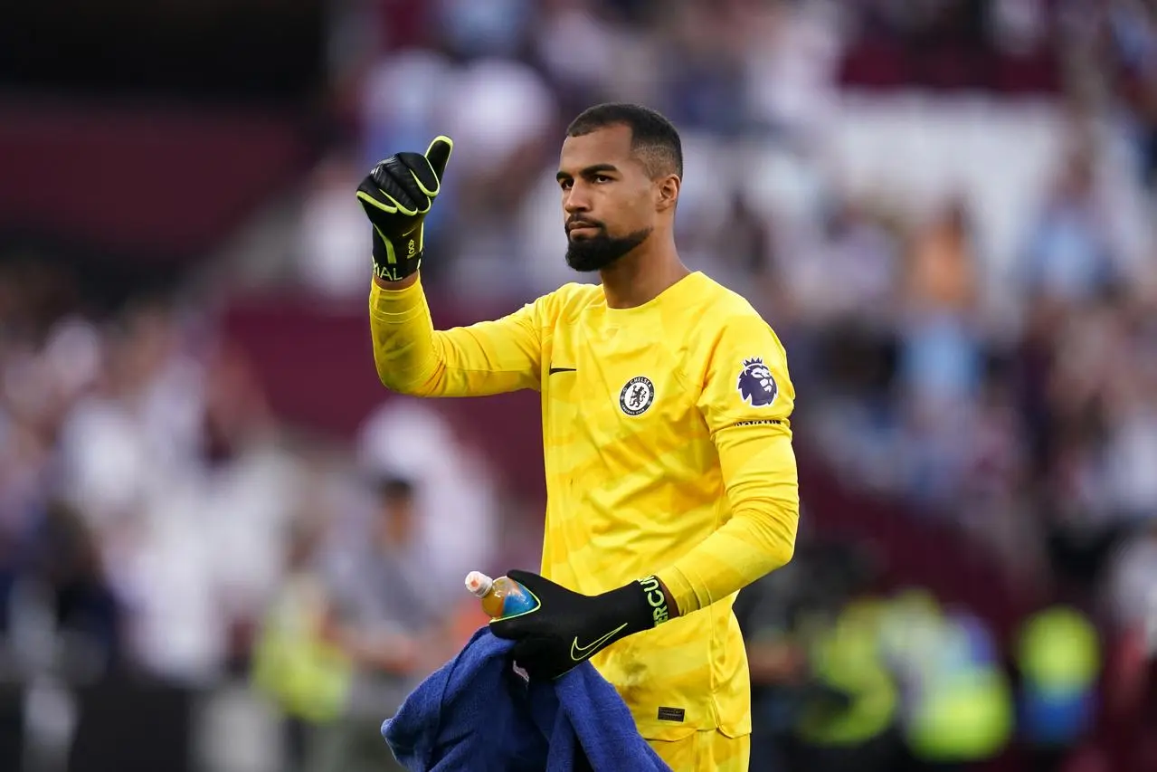 Chelsea goalkeeper Robert Sanchez raises his right fist in celebration