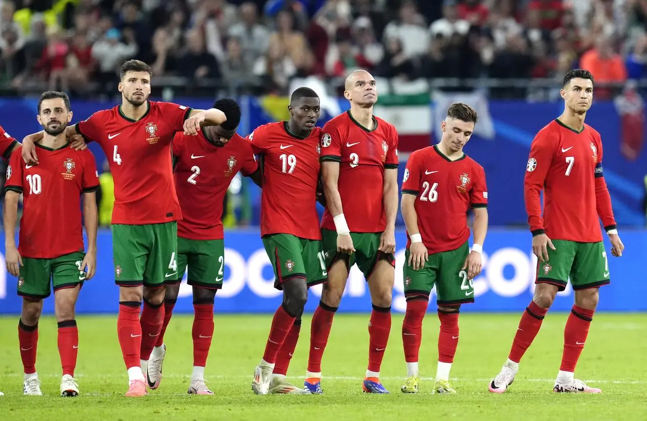 Portugal players dejected after losing on penalties