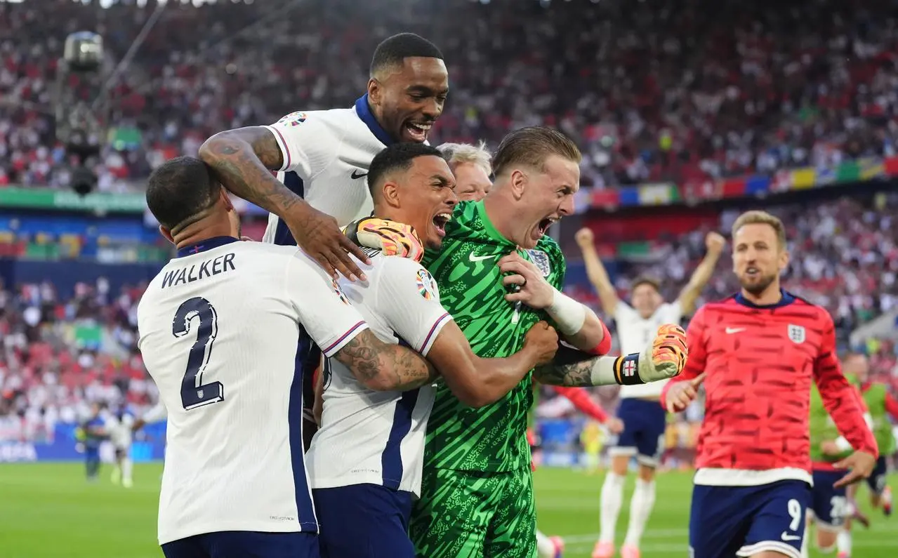 Trent Alexander-Arnold (centre) celebrates with England team-mates after scoring the winning penalty