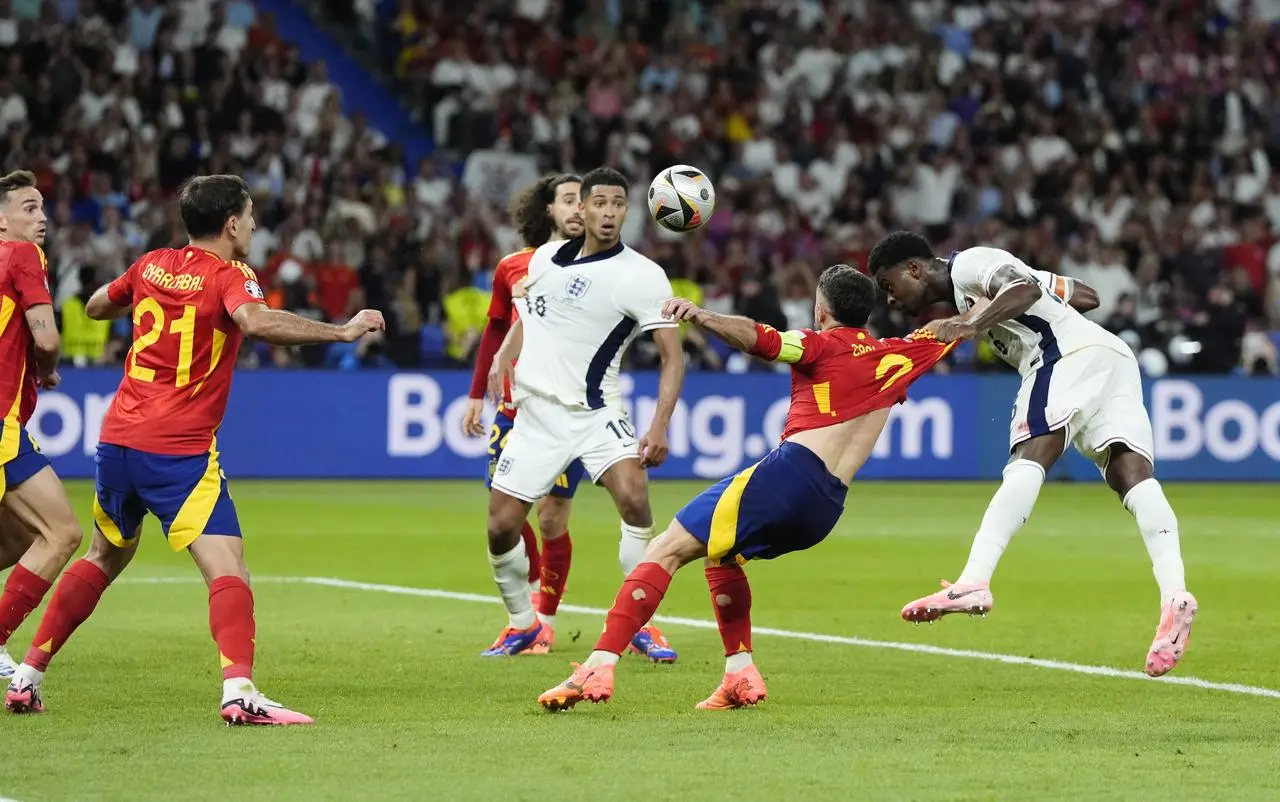 England’s Marc Guehi (right) has a late header towards the Spain goal that was cleared off the line by Dani Olmo