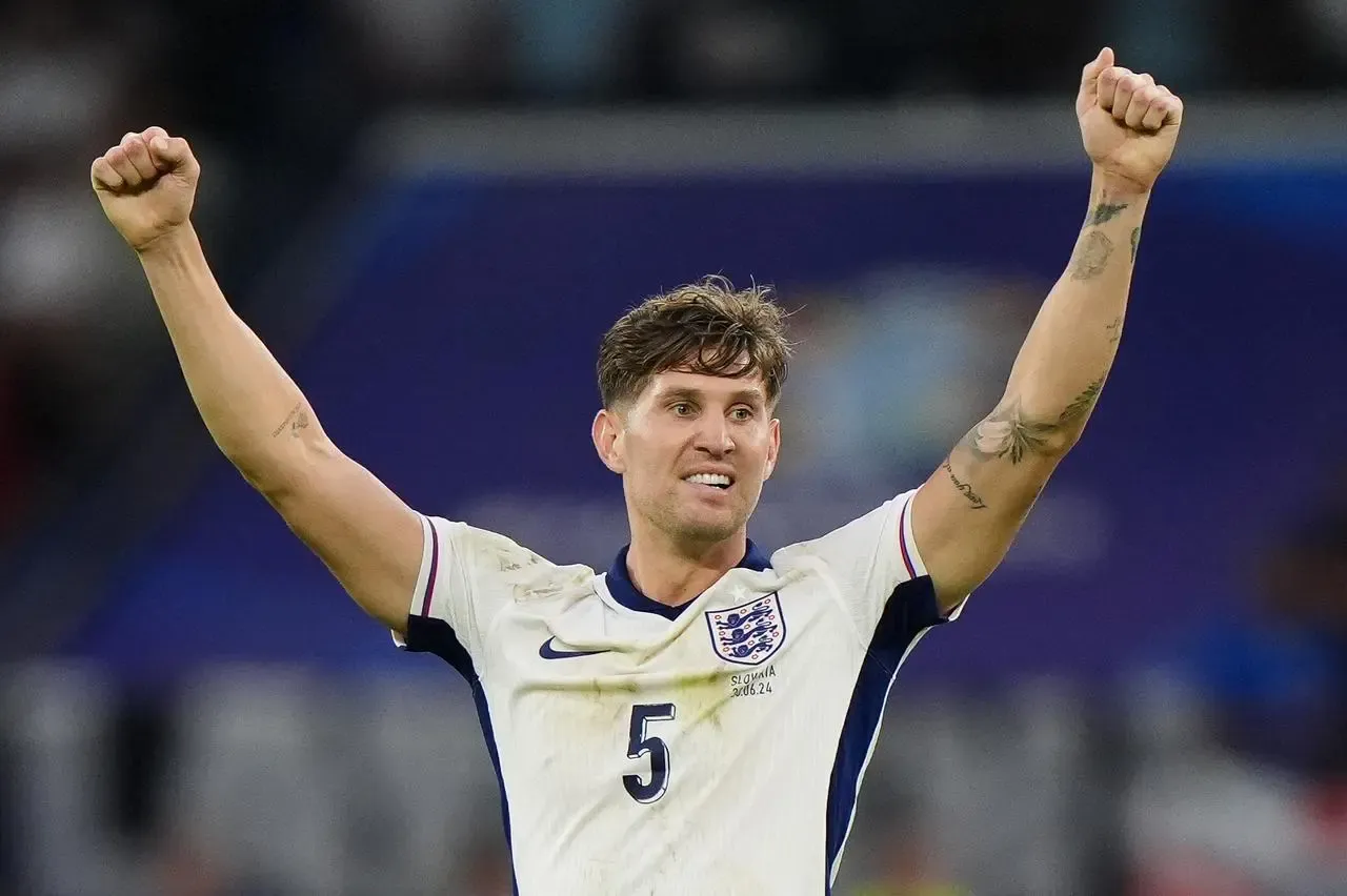 John Stones raises his arms after England beat Slovakia