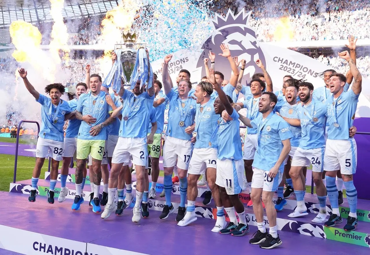 Manchester City players celebrate winning the 2023-24 Premier League title