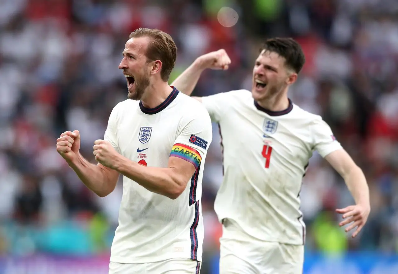 England captain Harry Kane clenches both fists and Declan Rice tenses his bicep during celebrations after the Euro 2020 win over Germany