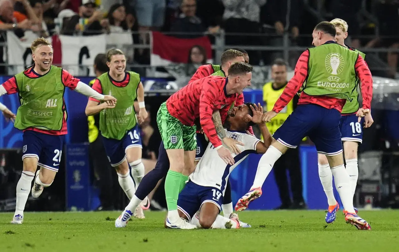 Ollie Watkins, centre, is grabbed by Dean Henderson as he celebrates with the England substitutes after scoring against the Netherlands