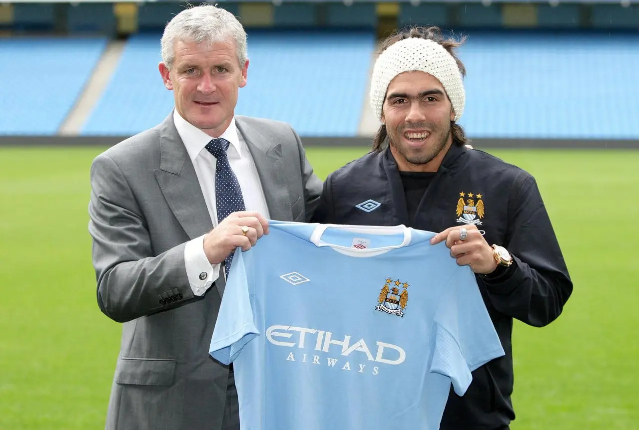 Carlos Tevez and Mark Hughes holding up a Manchester City shirt