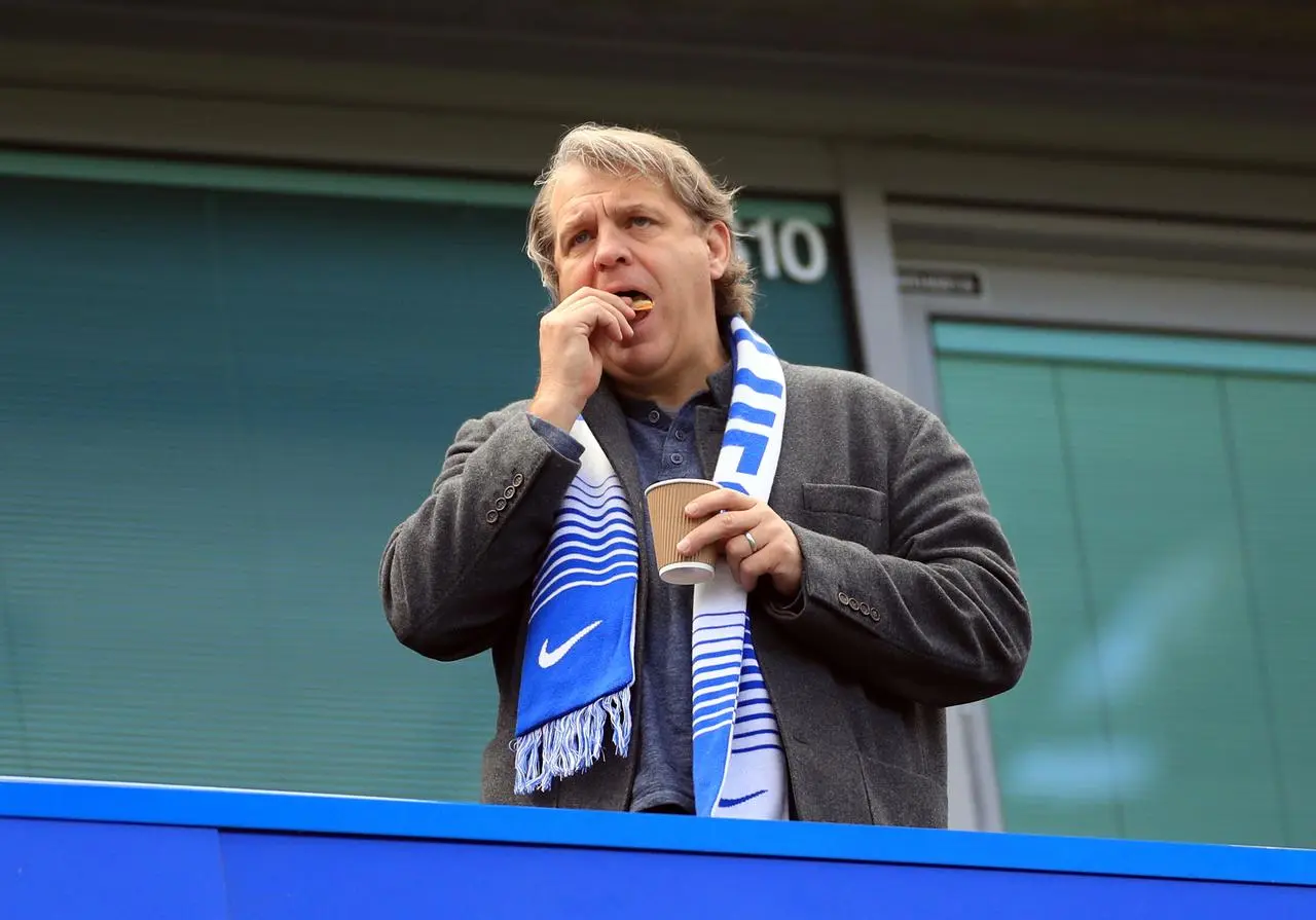 Chelsea owner Todd Boehly watches from a box while wearing a scarf