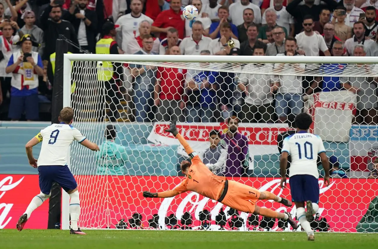 England’s Harry Kane, left, puts a penalty over the bar during the World Cup quarter-final against France in 2022