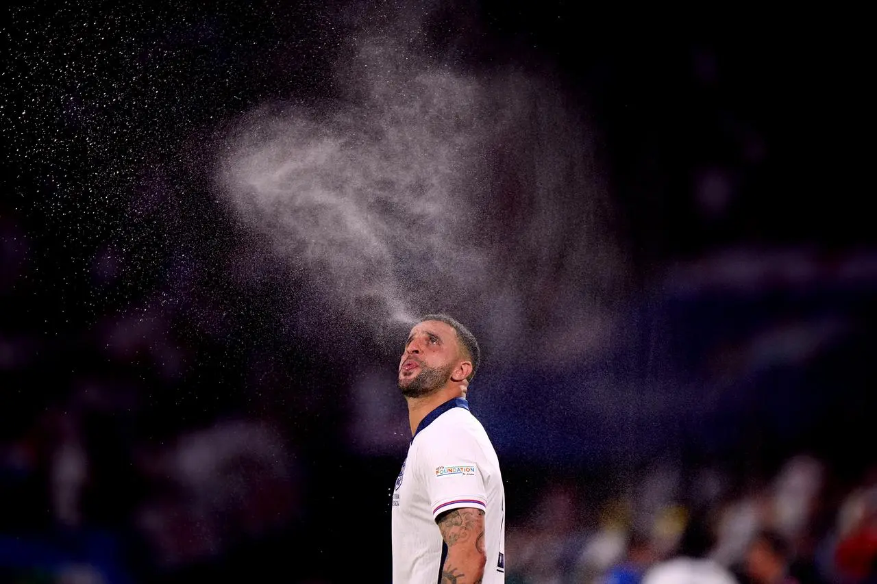 Kyle Walker spits out a spray of water before England's Euro 2024 game against Slovenia