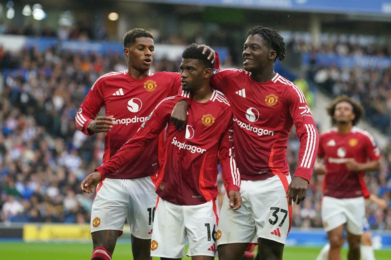 Marcus Rashford, Amad Diallo and Kobbie Mainoo celebrate a goal