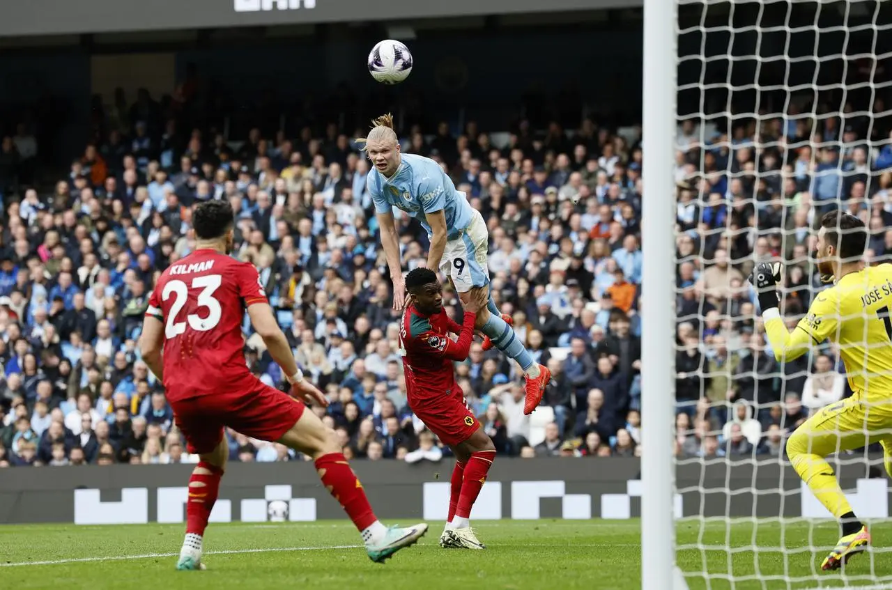 Erling Haaland, top, climbs above Wolves' Nelson Semedo, centre, to head Manchester City's second goal at the Etihad Stadium in May 2024 as Max Kilman, left, and goalkeeper Jose Sa watch on