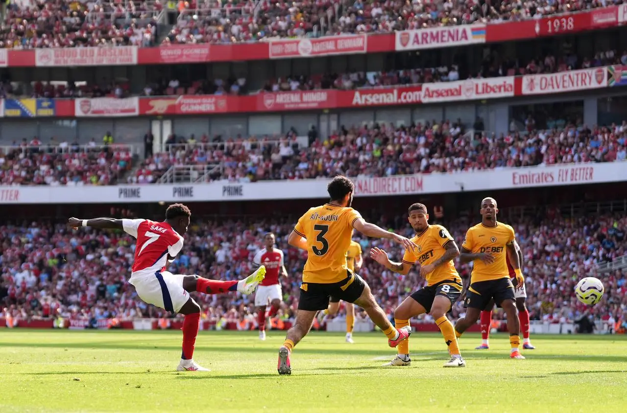 Bukayo Saka shoots left-footed past Wolves defenders to score his side's second goal