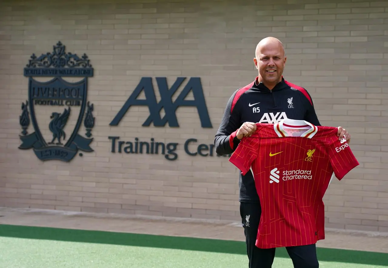 New Liverpool manager Arne Slot holds a team shirt at his unveiling at the club's training ground